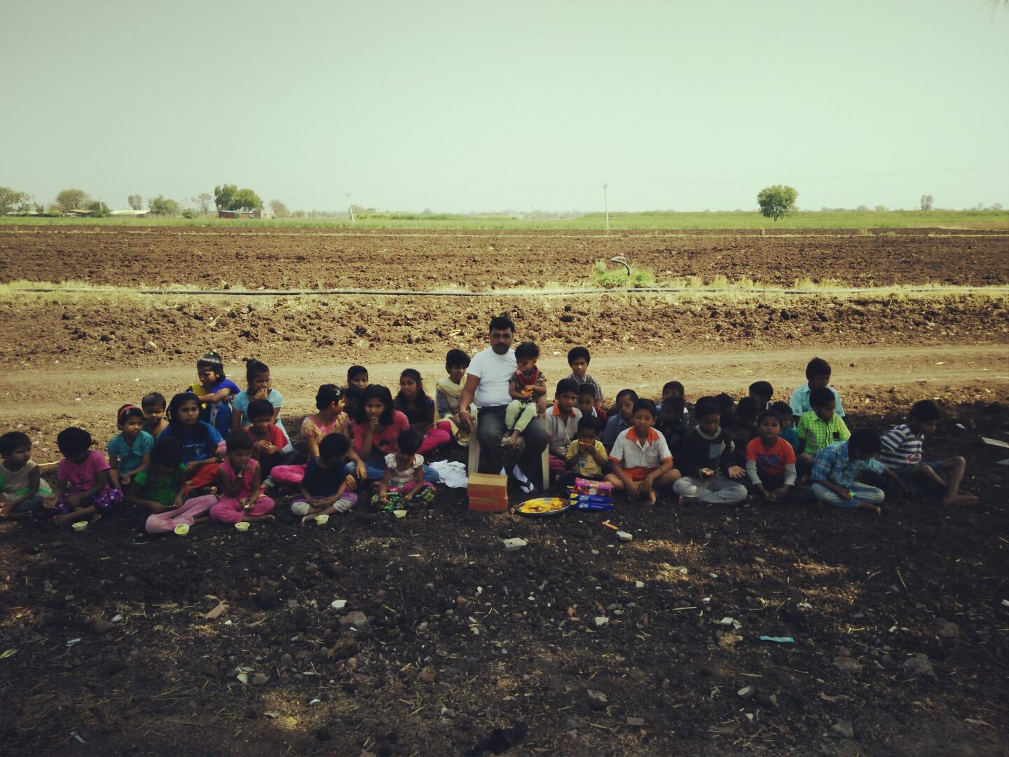 Children of SaiAshraya gathered for an outdoor meal