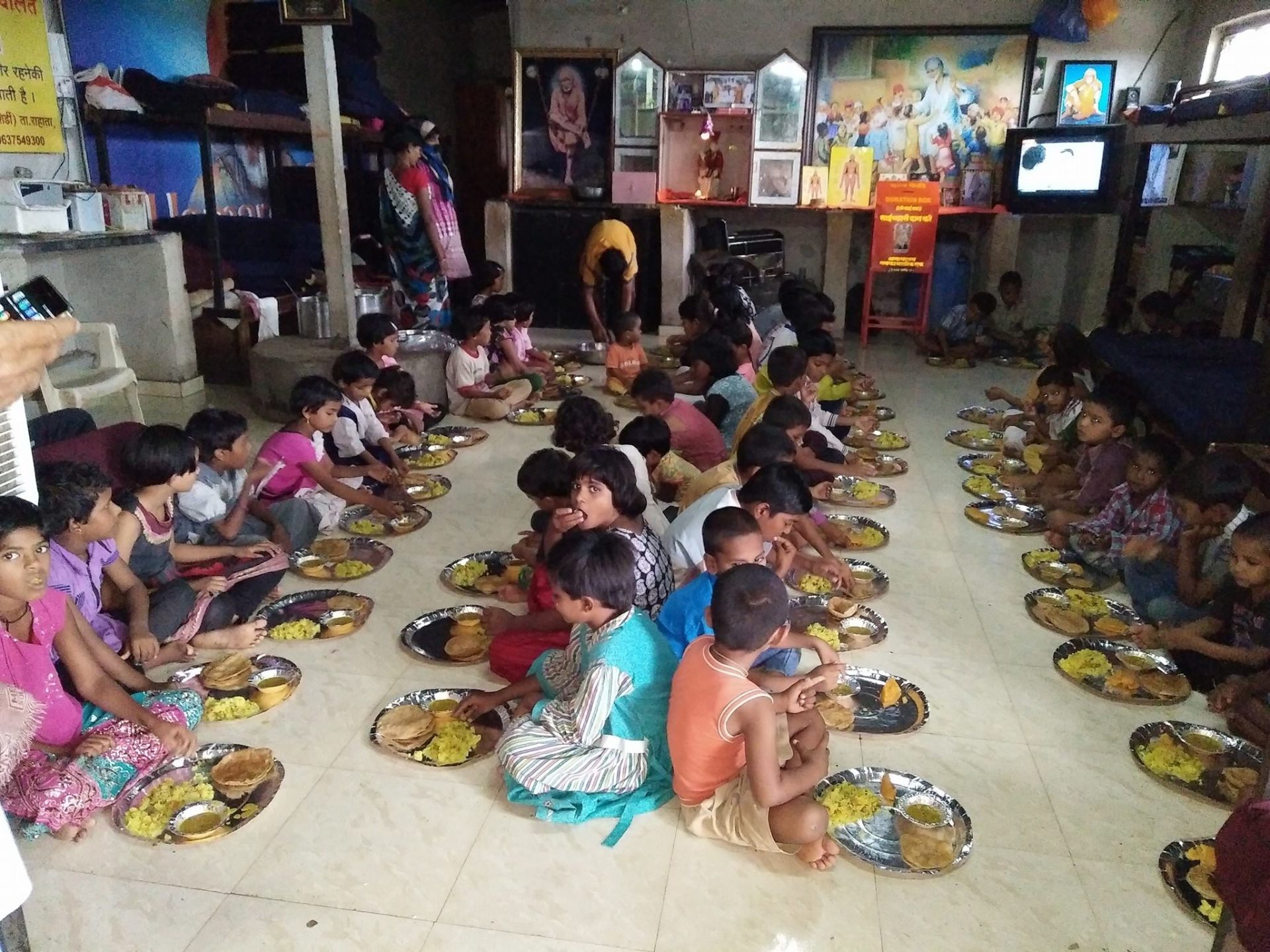 Children at SaiAshraya Family eating a hot meal together